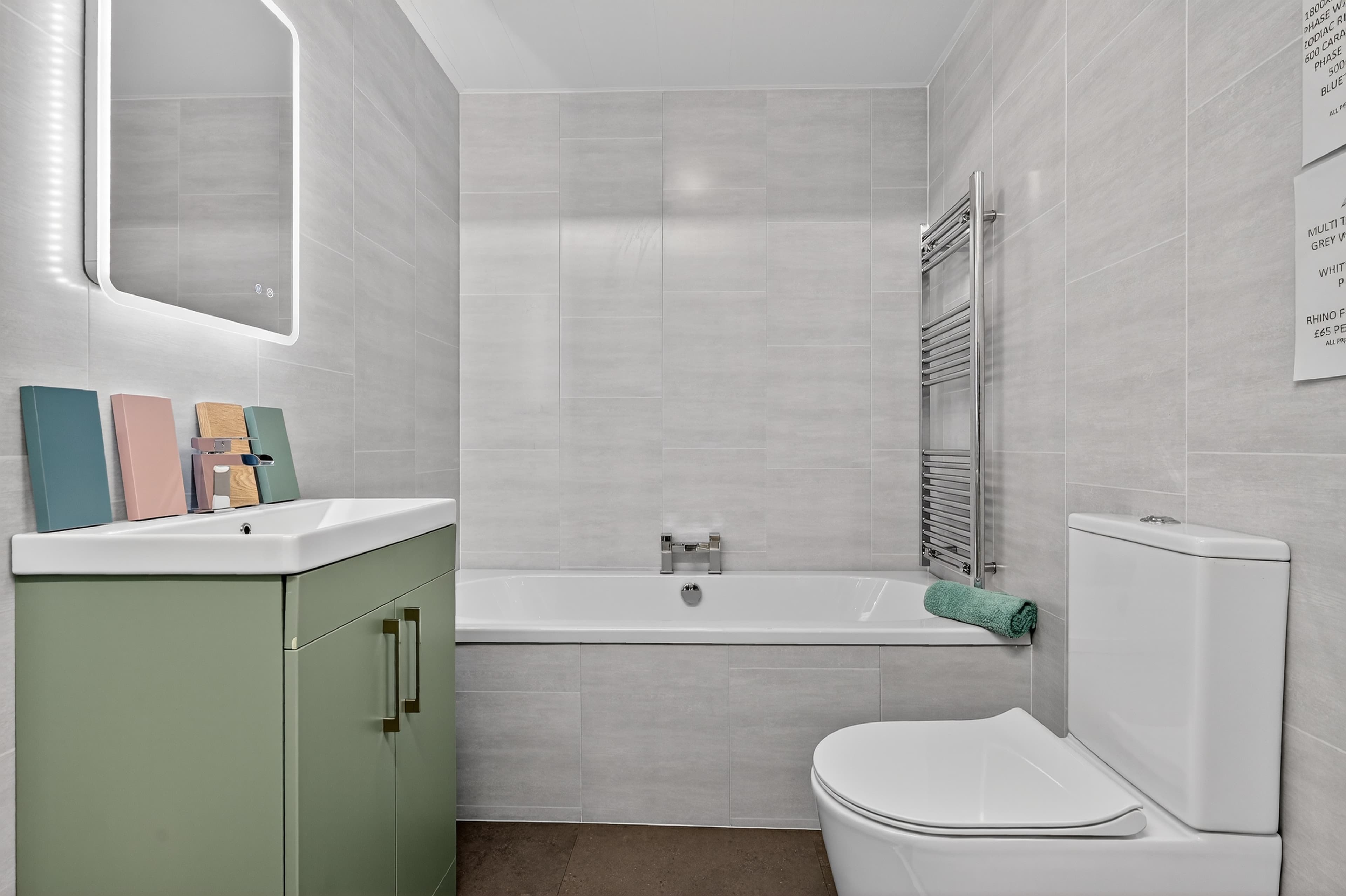 Tile effect PVC wall panels with sage green vanity unit and bath - M1 Bathrooms Belfast